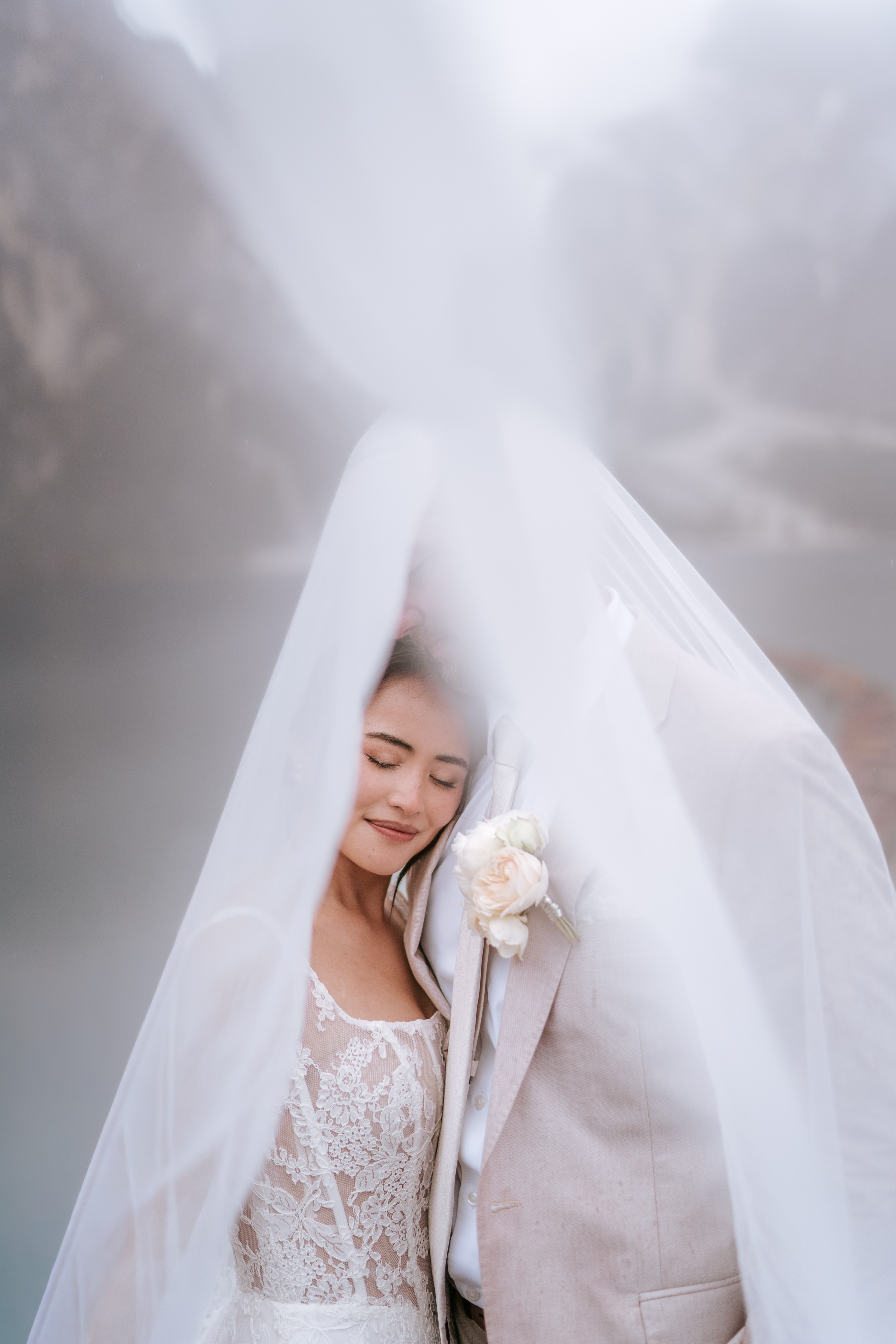 Couple at Lago di Braies on a rainy morning – dramatic Dolomite mist and moody light, elopement photographer